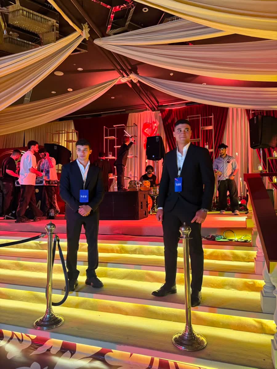 Kee ushers on duty at the foot of the stage during a gala